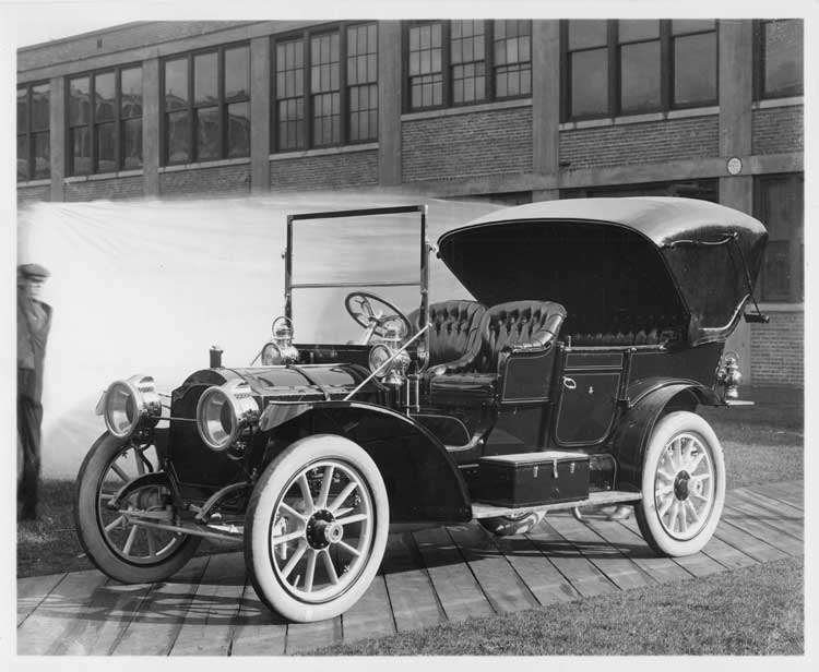 1909 Packard 30 Model UB touring car, left side, brick factory building in background