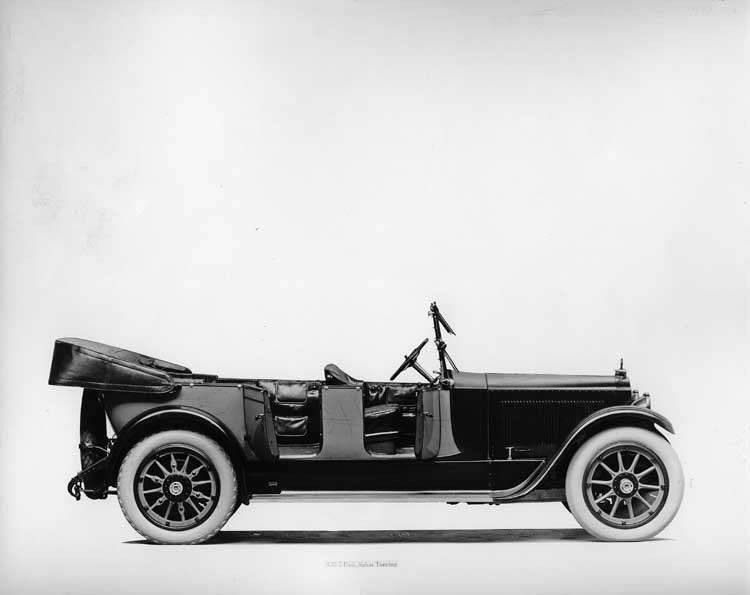 1918 Packard two-toned salon touring car, top folded, both doors opened, leather interior visible