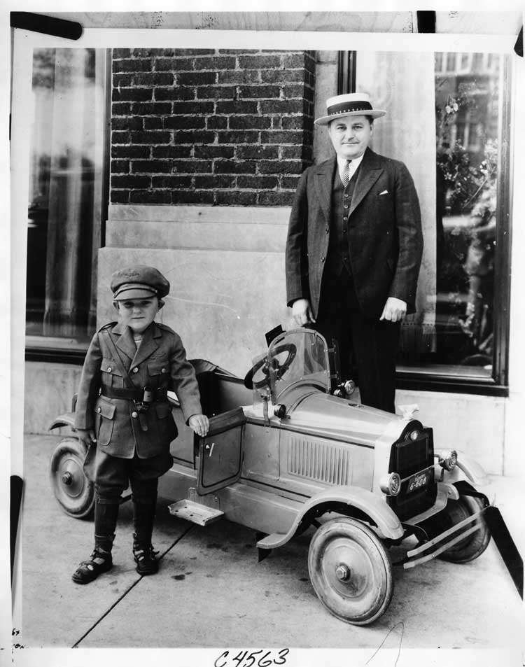 1924 Packard toy car runabout, pictured with man and small boy