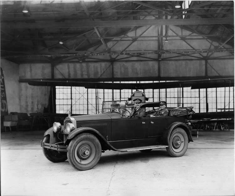 1924 Packard touring car with Army lieutenants in airplane hanger