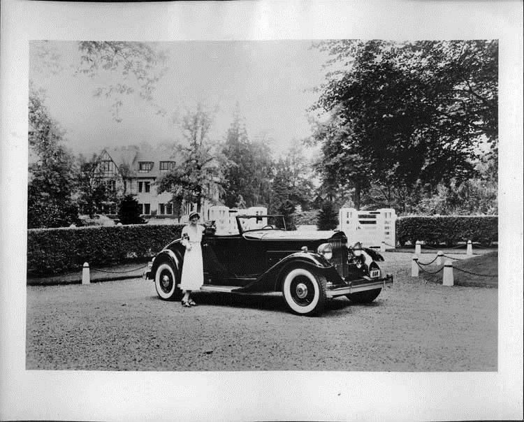 1933 Packard coupe-roadster in front of mansion