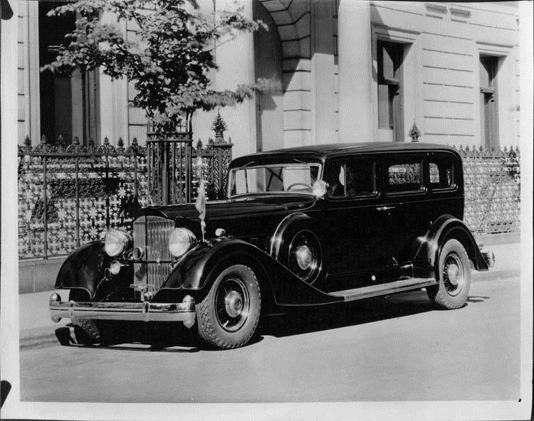 1934 Packard special sedan limousine, three-quarter left side view, parked on street