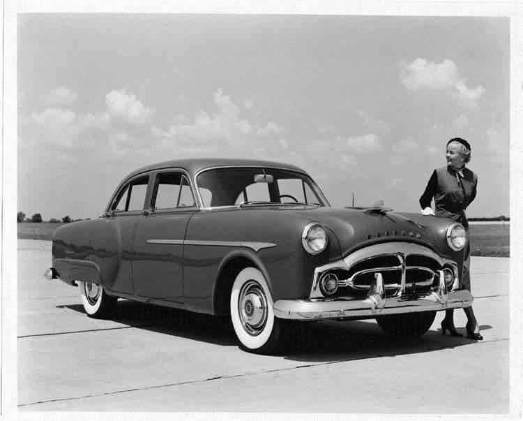 1951 Packard 200 touring sedan, female standing at front left side