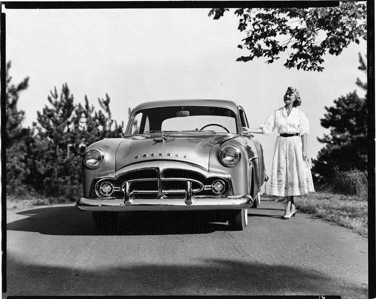1951 Packard 200 sedan, front view, parked on hill, female standing at driver's door