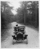 1907 Packard 30 Model U on wooded road with female driver