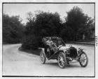 1907 Packard 30 Model U roadster on residential street, Henry Joy driver
