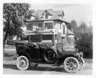 1909 Packard 30 Model UB touring car, parked on street in front of large house