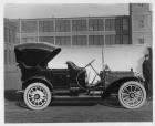 1909 Packard 30 Model UB touring car in front of brick factory building