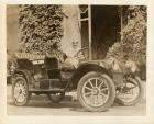 1910 Packard 18, parked on street with male driver