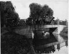 1914 Packard 2-38 salon touring car, driving on stone bridge over water