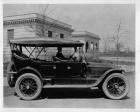 1916 Packard 1-25 touring car with long mileage record, parked in front of large stone building