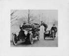 1916 Packard 1-25 phaeton, driving alongside a motorcycle and sidecar with two policemen