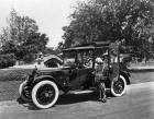 1918 Packard landaulet, parked on street, male driver, two female passengers, one female standing ne