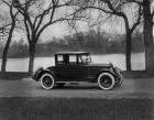 1921 Packard coupe, parked on road next to water and trees