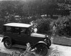 1921-1922 Packard sedan parked in drive next to garden