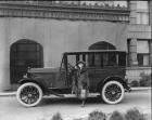 1920-1921 Packard sedan parked in front of stone building