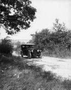 1920-1923 Packard touring car, on country road with male driver, top raised