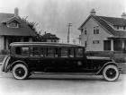 1920-1923 Packard special 8-door bus parked on residential street