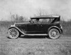 1922-1923 Packard touring car, left side view, top raised, male driver, on country road