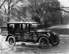 1923 Packard sedan, three-quarter right front view, parked on street, female passenger