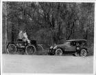1924 Packard touring car and 1899 Packard model A on wooded road