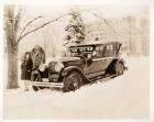 1925-1926 Packard touring car on snowy day, with couple