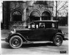1925-1926 Packard coupe, parked on street in front of house, female driver