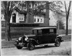 1927 Packard club sedan, three-quarter left front view, parked on street in front of brick house