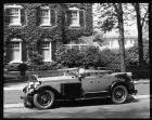 1927 Packard phaeton, two trunks on running board, parked in front of house