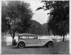 1928 Packard phaeton, nine-tenths right rear view, top raised, water and trees in background