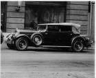 1929 Packard convertible sedan, nine-tenths left front view, top raised, parked on street