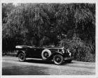 1930 Packard touring car, three-quarter right side view, top folded, parked on country road