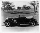 1931 Packard convertible victoria, left side view, top folded, in park setting