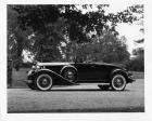 1932 Packard coupe roadster, left side view, top folded, female driver and passenger