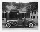 1932 Packard phaeton, left side view, top folded, owner Tommy Milton standing at side