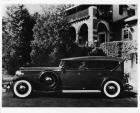 1932 Packard touring car, left side view, top raised, parked in drive