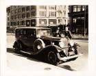 1932 Packard sedan on city street in front of Packard dealer