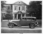 1932 Packard sedan, left side view, parked on drive in front of house, male driver