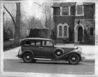 1933 Packard sedan, right side view, parked on street in front of house