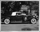 1934 Packard coupe roadster, right side view, top raised, parked on street