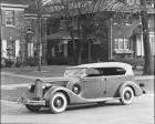 1935 Packard phaeton, three-quarter left side view, top raised, parked on street