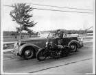 1935 Packard touring car being pulled over by a motorcycle policeman