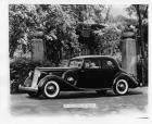 1936 Packard coupe, parked in front of gateway, house in background