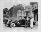 1936 Packard coupe, female handing keys to male at driver's door