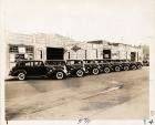 1937 Packard business limousines, parked on street in front of Sunoco Oil