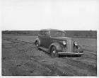 1937 Packard touring sedan in dirt field at Packard Proving Grounds