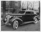 1937 Packard convertible sedan, three-quarter left front view, top raised, parked by church