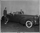 1940 Packard convertible victoria in front of backdrop