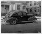 1940 Packard touring sedan, passenger's side, parked on street, covered in mud