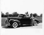 1941 Packard convertible, female sitting in back, female opening driver's door
